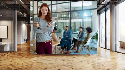 Flaunt your confidence. Portrait of a young creative standing in an office with colleagues in the background. Wall mural