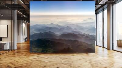 Aerial view of the mountains in the clouds. Wall mural