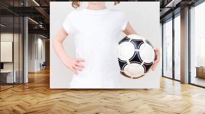 Little girl in white T-shirt with ball. Front view. Wall mural