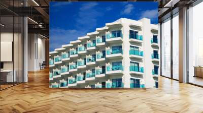 Portrait of hotel or apartment building with balconies. Wall mural