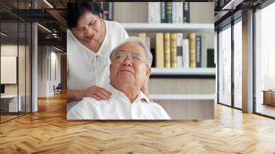 Loving Asian senior couple relaxing and sitting on sofa at home. Happy senior retirement lifestyle Wall mural