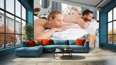 Peace, couple and spa for hot stone massage, relax on holiday and wellness with weekend break, smile and stress relief. Honeymoon, man and woman with vacation, rocks and time together with luxury Wall mural