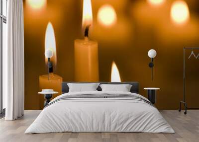 Three candles with glowing candles in background Wall mural