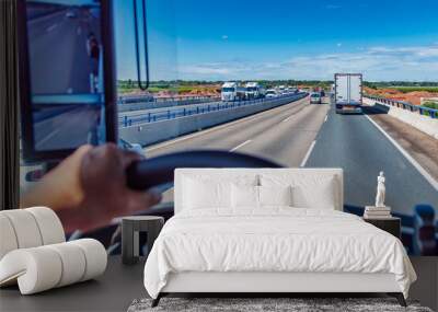 View from the driving position of a truck of a three-lane highway crowded with vehicles. Dense traffic. Wall mural