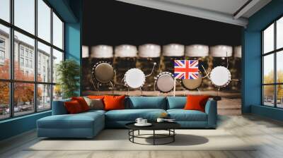 Crown cork miniature figures and beer glasses in the back, great britain flag, concept country beer culture Wall mural