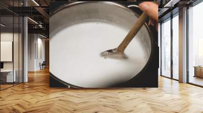 Fresh cheese making step by step, heating milk into a saucepan, homemade cottage cheese Wall mural