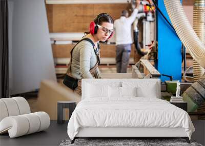 male and female carpenter at work, man and woman are crafting with wood in a workshop Wall mural