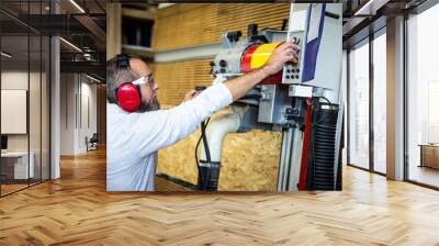 male craftman is working with a vertical panel saw Wall mural