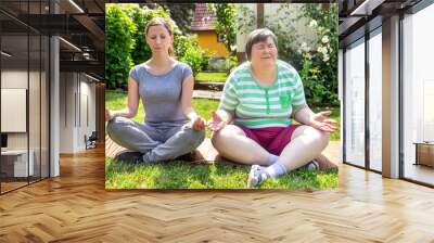 mentally disabled woman and coach is doing yoga exercises Wall mural