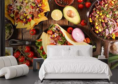 assorted of mexican food with fajitas, chili con carne and nachos with avocado, beef and cheese Wall mural