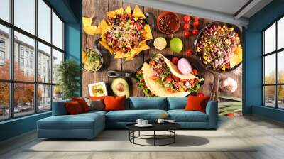 assorted of mexican food with fajitas, chili con carne and nachos with avocado, beef and cheese Wall mural