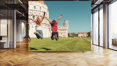 Happy family jumping in front of cathedral and leaning tower in Pisa- Travel, tour tourism, vacation in Italy Wall mural