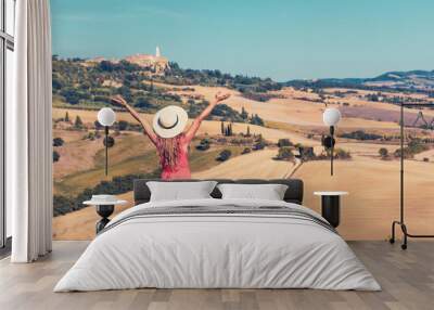 Happy woman with arms raised enjoying panoramic view of Tuscan landscape- tour tourism, travel, vacation destination in Italy Wall mural