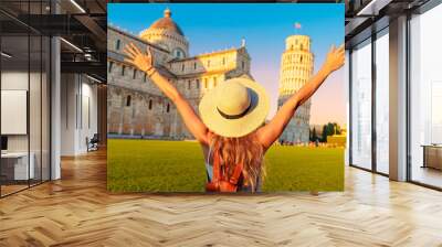 Happy young female traveler in front of the famous leaning tower in Pisa at the sunset- tour tourism, travel, vacation in Italy - Europe Wall mural