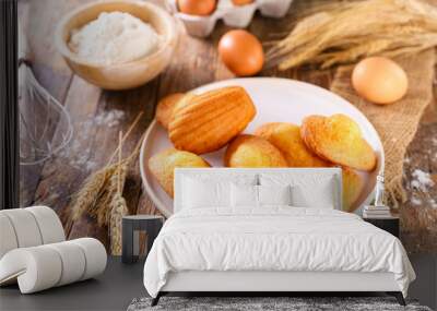 madeleine cake and ingredient on wood background Wall mural