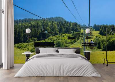 Panorama of green mountain in summer- chairlift Wall mural