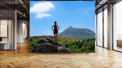 standing woman looking at panoramic view of Puy de Dome Wall mural