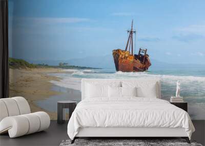 View of Abandoned vintage fishing boat on beach in Greece Wall mural