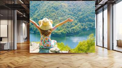 woman sitting on the mountain peak and amazing view of dordogne river and forest Wall mural