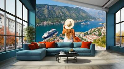 Woman tourist enjoying panoramic view of Kotor Bay- travel, tour tourism, vacation in Montenegro, Europe Wall mural