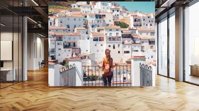 Woman tourist enjoying view of Setenil de las Bodegas white village in Spain Wall mural