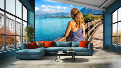 woman tourist looking at beautiful lake in switzerland Wall mural