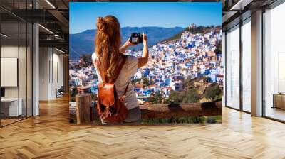 Woman tourist taking picture of blue city- Chefchaouen in Morocco Wall mural