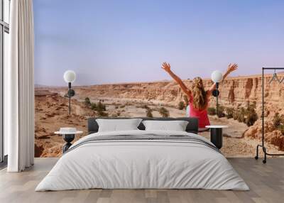 Woman with arms raised, cliff and canyon- Morocco Wall mural