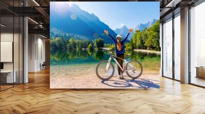 woman with arms raised enjoying beautiful emerald lake in Slovenia- travel, vacation,tourism in Europe Wall mural