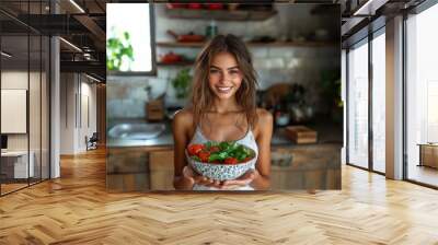 Smiling Woman Holding Fresh Salad in a Rustic Kitchen. Embracing Fitness, Diet, and Nutrition Wall mural