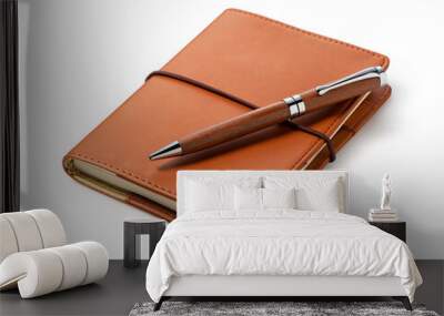 A leather notebook and pen set against a white background. Wall mural