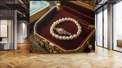 A vintage-style pearl necklace with an ornate clasp, displayed in its original velvet box on the table of an antique jewelry store. Wall mural