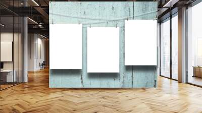 Close-up of three hanged paper sheets with pegs on weathered aqua wooden boards background Wall mural