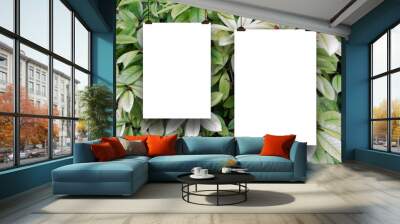 Close-up of two blank frames hanged by clips against green and grey foliage background Wall mural