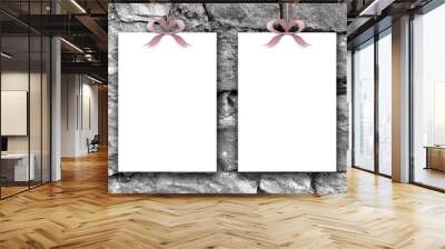 Close-up of two hanged paper sheets with violet ribbons on ancient stone wall background Wall mural