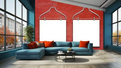 Close-up of two square blank frames hanged by clothes hanger against red rough concrete wall background Wall mural