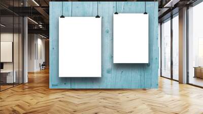 Two blank frames hanged by clips against aqua wooden boards background Wall mural