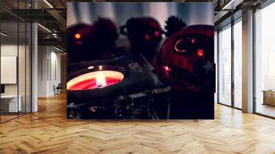 Christmas candles, red apples, cones and spices on rustic wooden background with  Balls and Christmas lights. Close up, selective focus  Wall mural