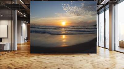 Wide panorama of waves coming in at the Arpoador Devil's beach in Rio de Janeiro, Brazil, at sunrise with the sun reflecting in the water that hits the pristine sand beach Wall mural