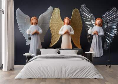 3 angels of light with wings on black background Wall mural