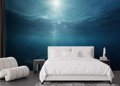 dark blue water of a deep sea with sun glare in the sky peaceful underwater landscape Wall mural