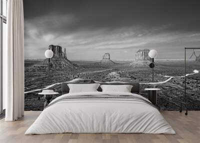 black and white photo of monument valley with car lights trails at night, usa. Wall mural