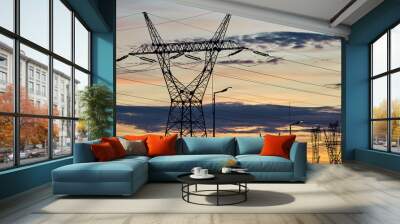 Power transmission towers silhouettes at sunset. Wall mural