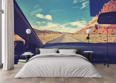 Vintage toned photo of a road taken from the front seat of a car, travel concept, USA. Wall mural