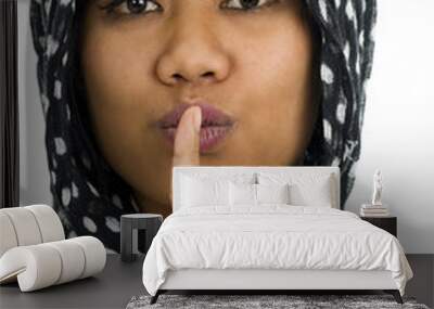 asian with finger on her lips Wall mural