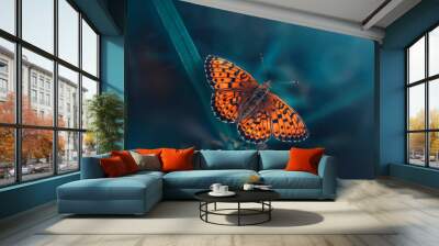 Macro or an orange butterfly on teal and green colored grass. Shallow depth of field, dreamy and magical scenery, light shining from the corner. Wide horizontal photo Wall mural