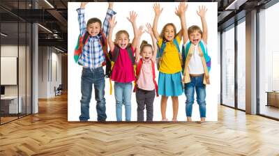 A group of happy school children with backpacks standing and holding their hands up Wall mural