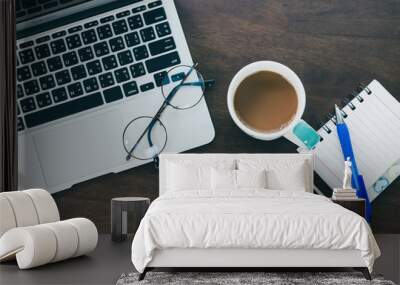 top view of office desk workspace with coffee cup, notebook, smartphone and keyboard on wood background with copy space, Wall mural