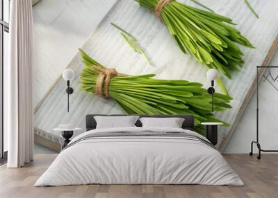 Fresh barley grass on a white table Wall mural