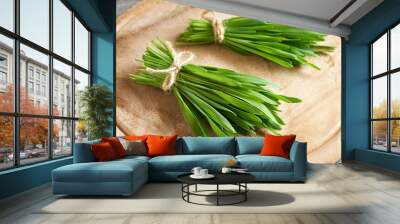 Fresh green barley grass on a wooden cutting board Wall mural